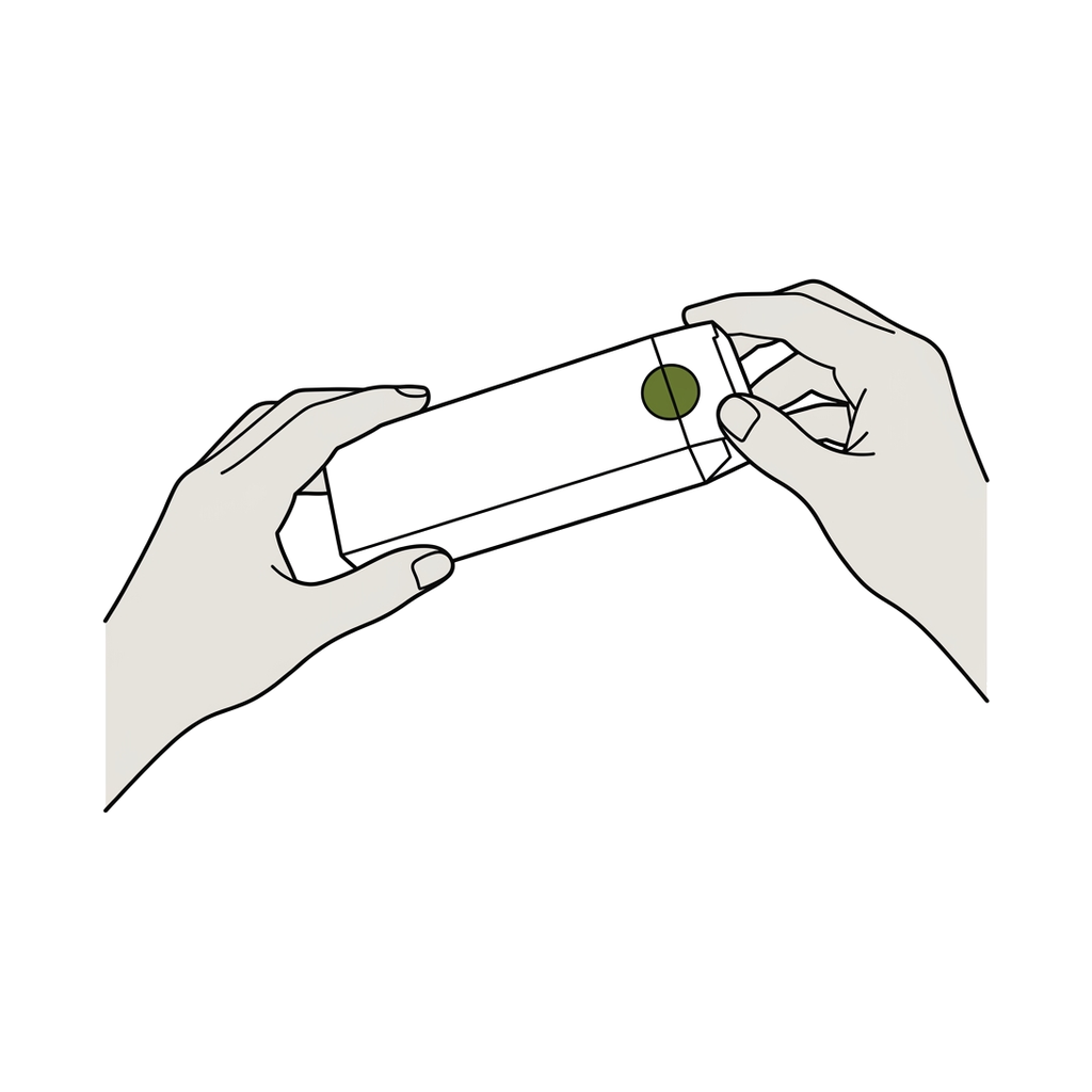 Two hands holding a slim white carton, checking that the round seal on the end flap is intact